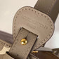 Close-up of a Louis Vuitton bag strap with gold hardware.