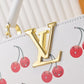 Designer handbag with gold logo and cherry pattern