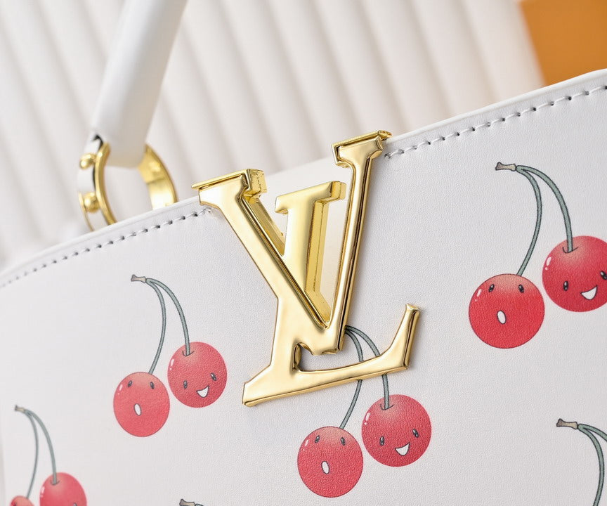Designer handbag with gold logo and cherry pattern
