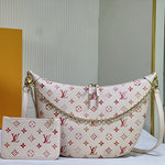 White handbag with red monogram pattern and matching pouch on a light gray background